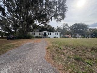 3431 Maple Drive Mulberry, FL 33860 - Photo 14 of 14 a view of swimming pool with trees in the background
