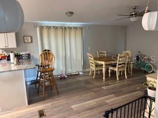 3431 Maple Drive Mulberry, FL 33860 - Photo 3 of 14 a dining room with furniture floor to ceiling window and wooden floor
