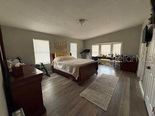 3431 Maple Drive Mulberry, FL 33860 - Photo 7 of 14 a spacious bedroom with a bed couch tv and window