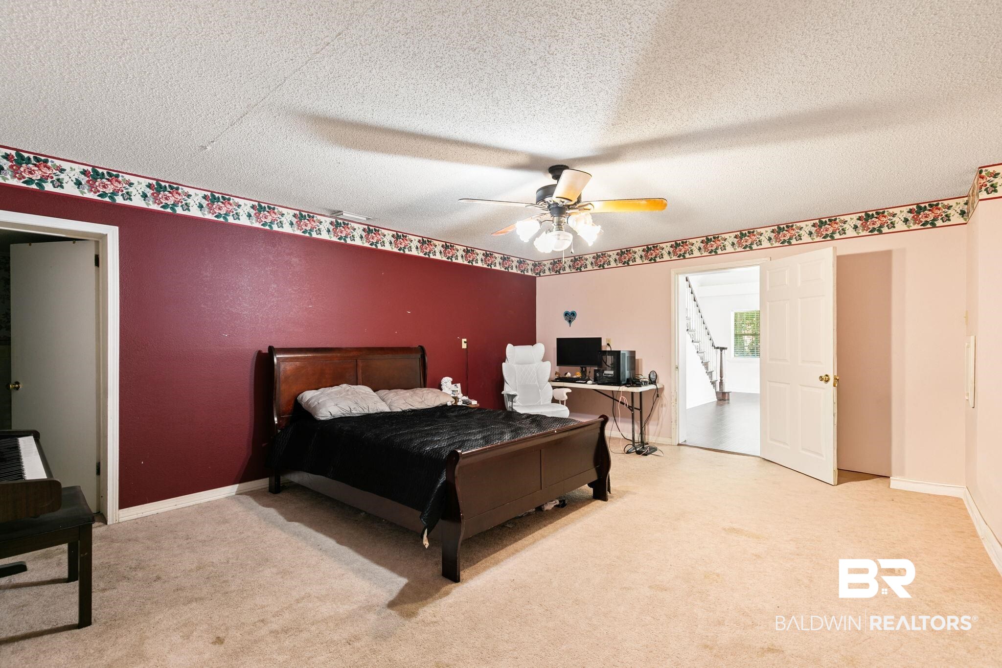 927 Cleveland Road Saraland, AL 36571 - Photo 19 of 80 Spacious room featuring carpeting, a ceiling fan with light fixture, and double doors opening to a staircase