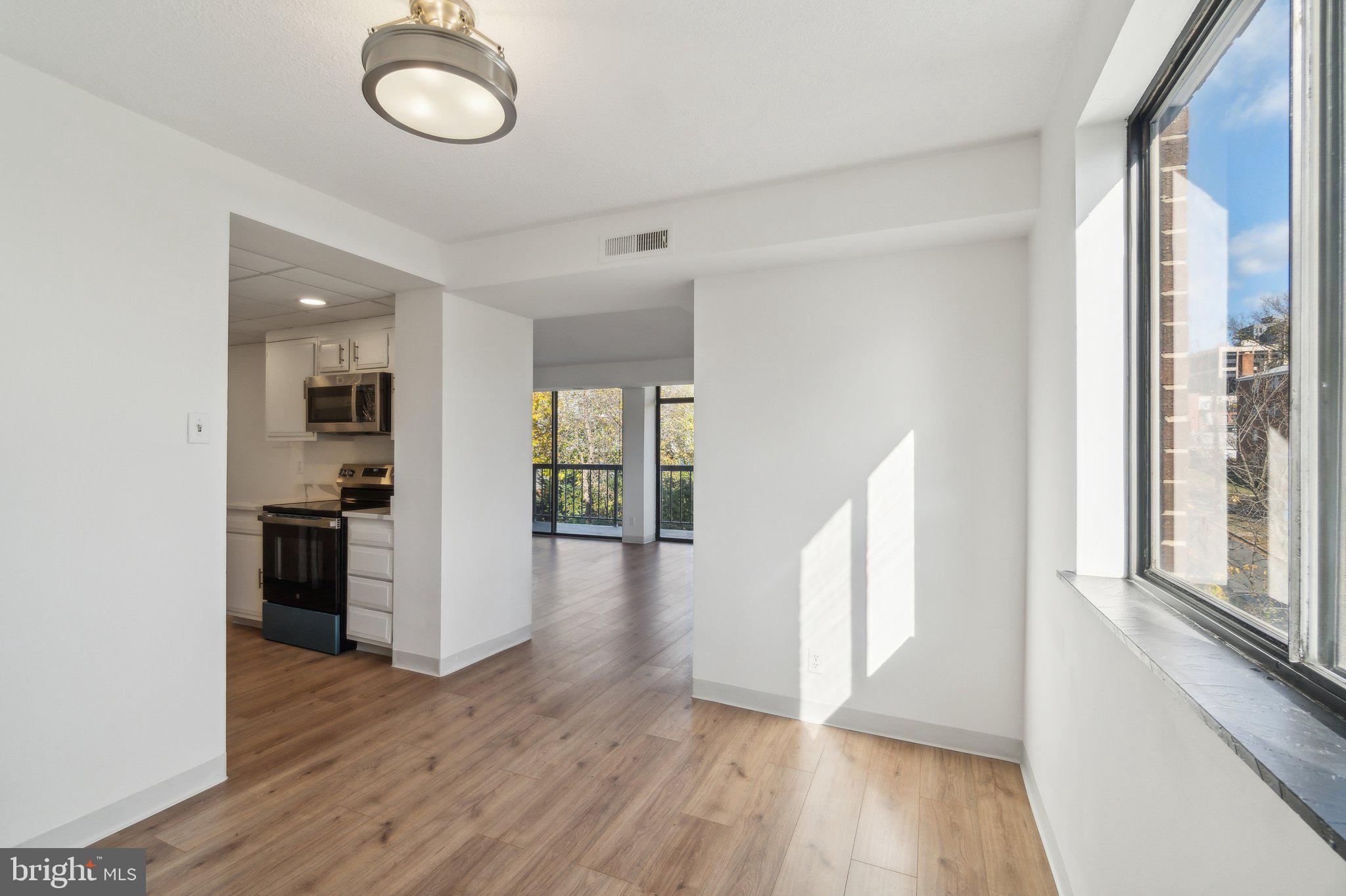 1401 North Rhodes Street, Unit 305 Arlington, VA 22209 - Photo 13 of 35 wooden floor in an empty room with a window