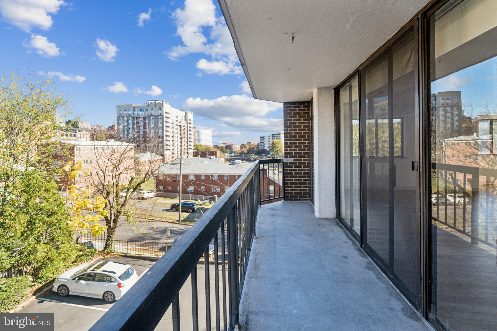 1401 North Rhodes Street, Unit 305 Arlington, VA 22209 - Photo 33 of 35 a view of a balcony with wooden floor and stairs