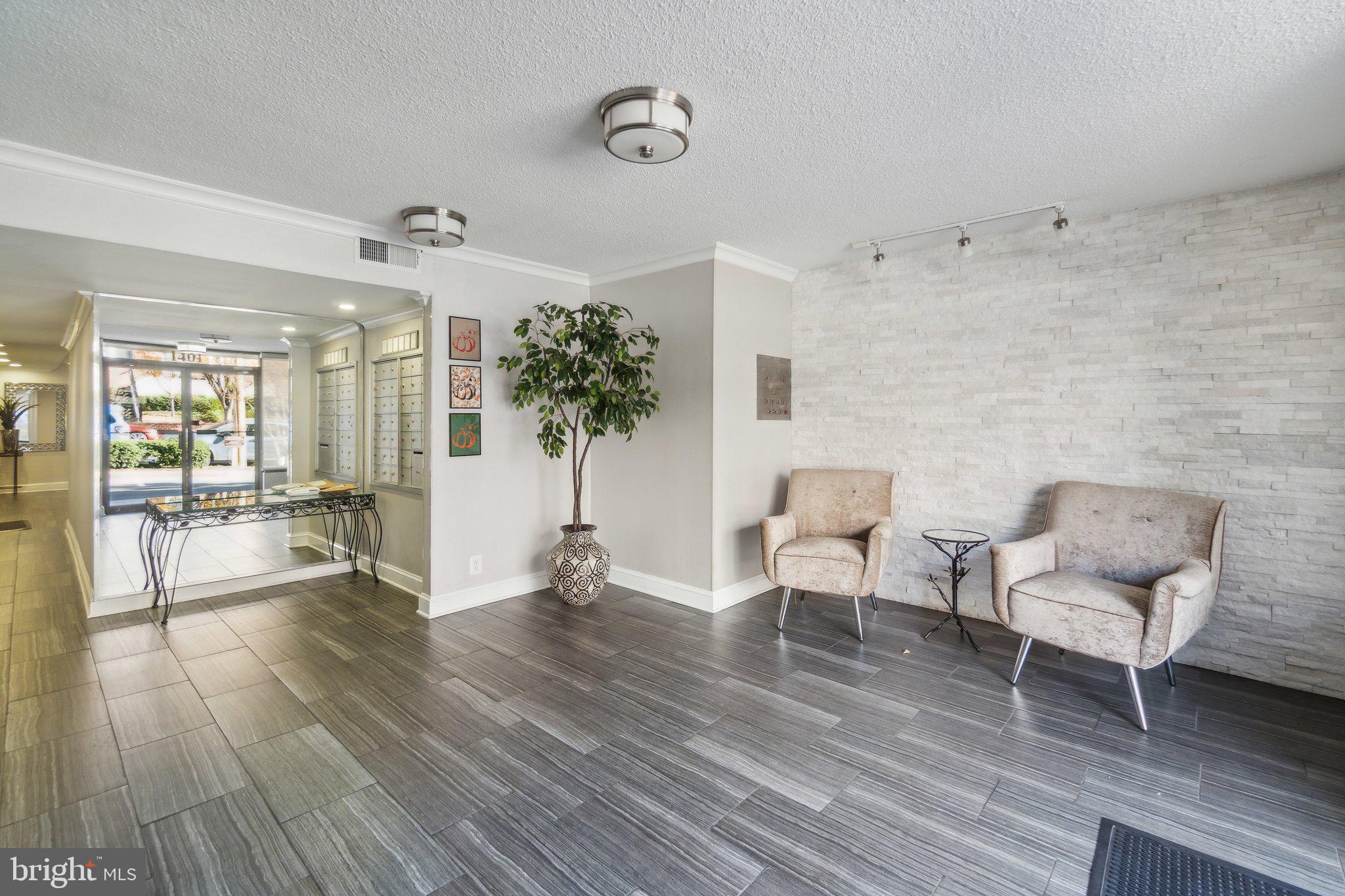 1401 North Rhodes Street, Unit 305 Arlington, VA 22209 - Photo 6 of 35 a living room with furniture and a wooden floor