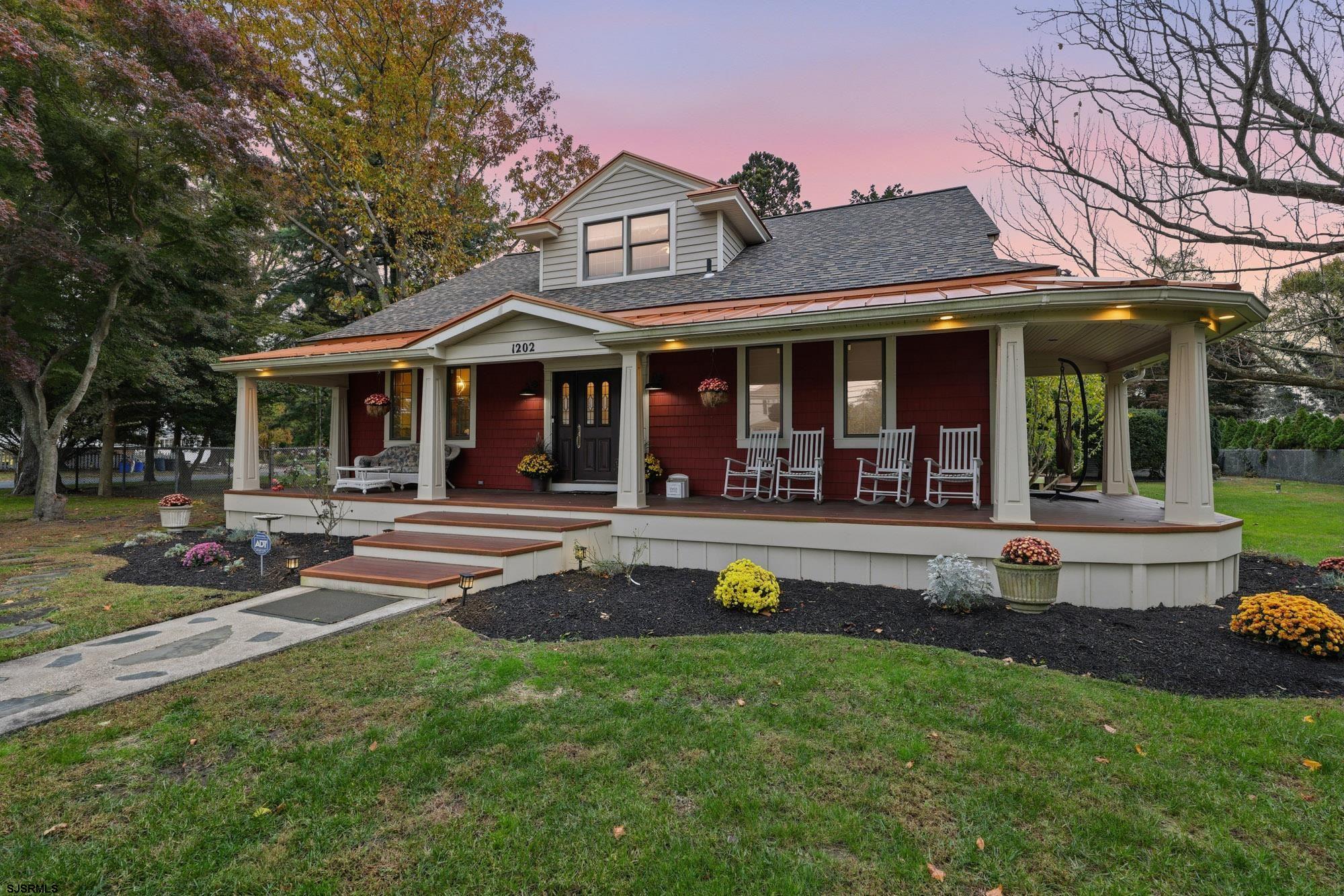 a view of a white house with a swimming pool and porch