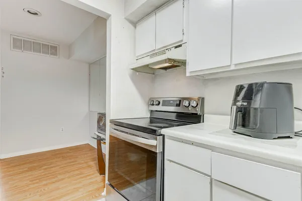 a kitchen with stainless steel appliances granite countertop a sink and a stove