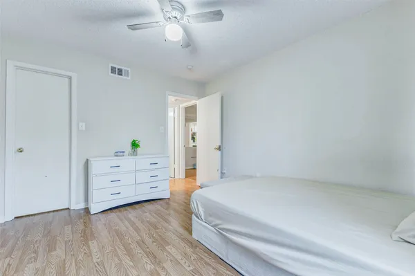 a bedroom with a bed and a dresser