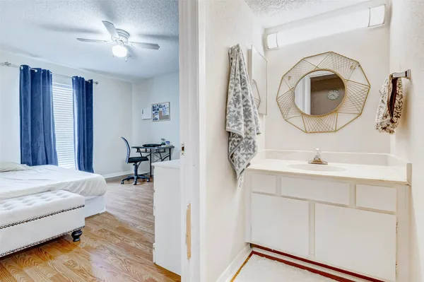 a en suite bathroom with a sink and a mirror