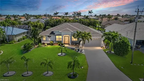 an aerial view of a house with swimming pool and garden