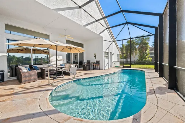 an aerial view of residential houses with outdoor space and swimming pool