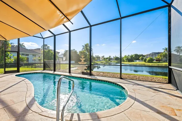 a living room with furniture chandelier and a window