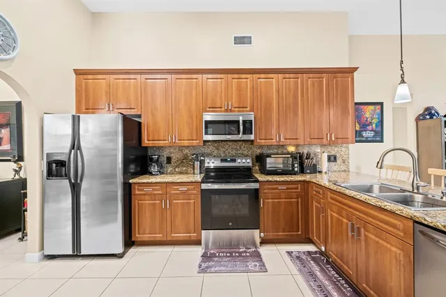 a living room with furniture a flat screen tv and a floor to ceiling window