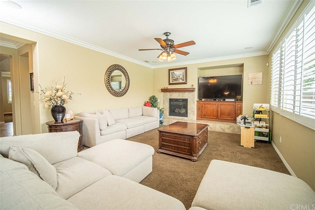 18622 Lurin Avenue Riverside, CA 92508 - Photo 15 of 33 a living room with furniture a fireplace and a large window
