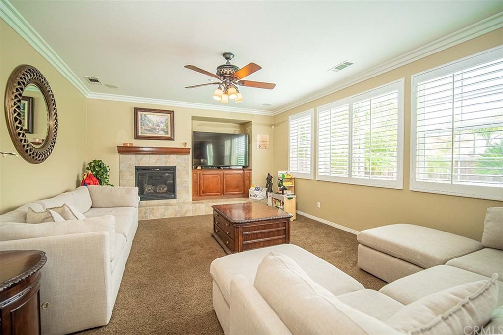18622 Lurin Avenue Riverside, CA 92508 - Photo 16 of 33 a living room with furniture a fireplace and a large window