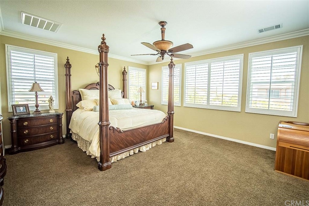 18622 Lurin Avenue Riverside, CA 92508 - Photo 18 of 33 a spacious bedroom with a bed and a chandelier