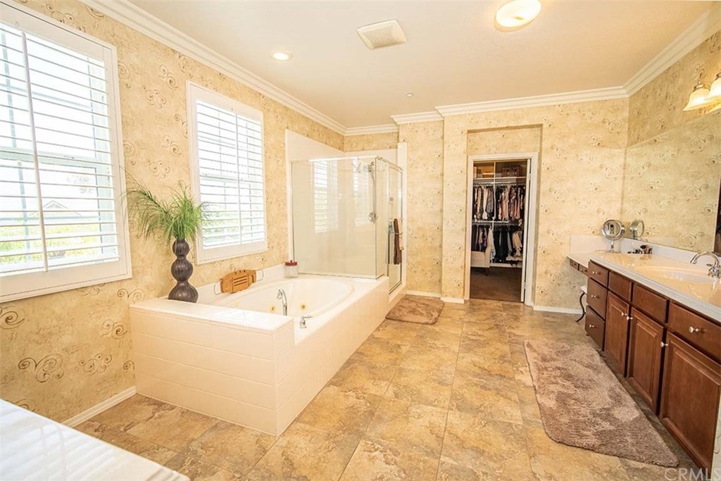 18622 Lurin Avenue Riverside, CA 92508 - Photo 22 of 33 a spacious bathroom with a tub sink shower and mirror