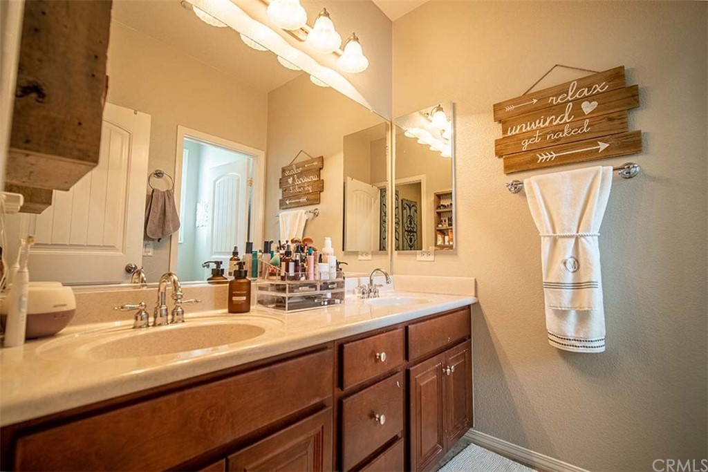 18622 Lurin Avenue Riverside, CA 92508 - Photo 24 of 33 a bathroom with a double vanity sink and a mirror