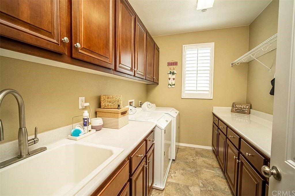 18622 Lurin Avenue Riverside, CA 92508 - Photo 25 of 33 a kitchen with a sink and a refrigerator