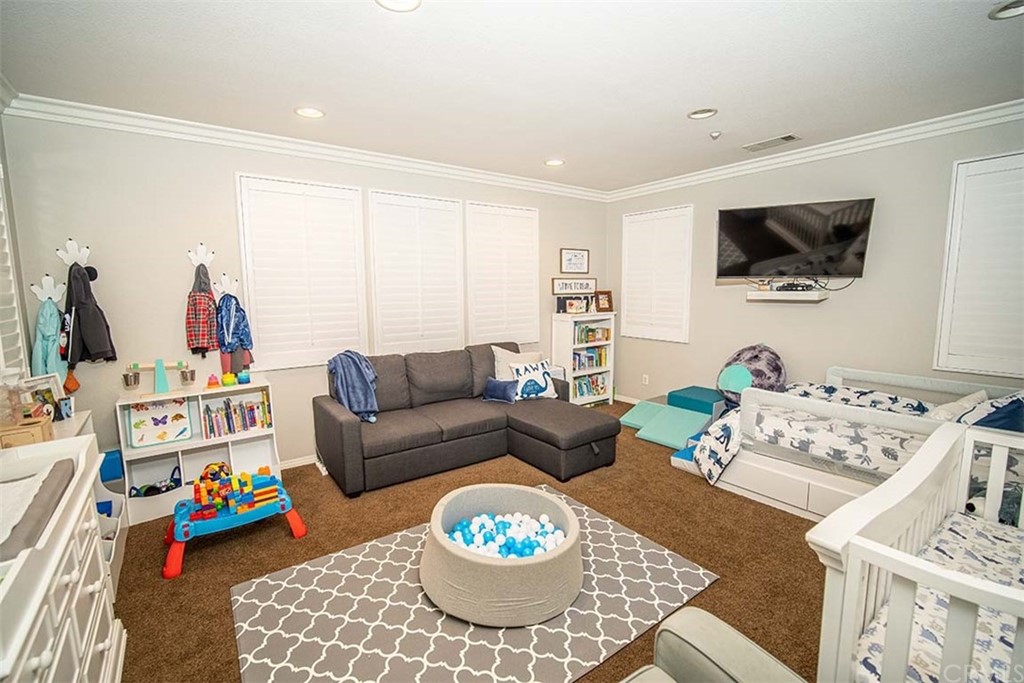 18622 Lurin Avenue Riverside, CA 92508 - Photo 27 of 33 a living room with furniture and a flat screen tv