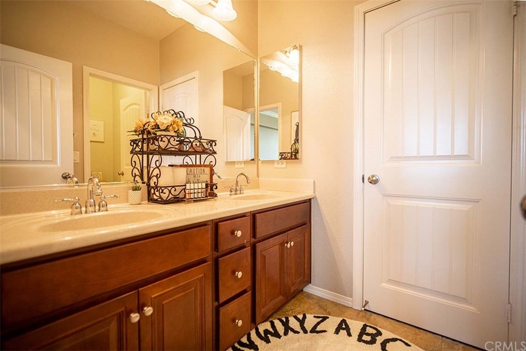 18622 Lurin Avenue Riverside, CA 92508 - Photo 28 of 33 a bathroom with a sink and a mirror