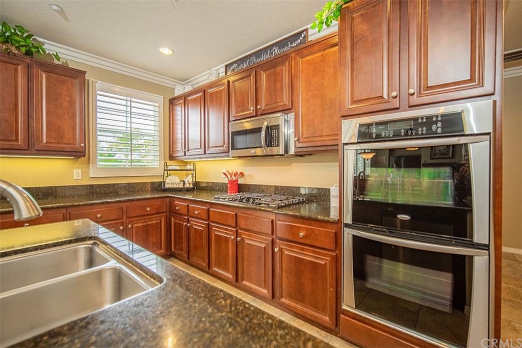 18622 Lurin Avenue Riverside, CA 92508 - Photo 10 of 33 a kitchen that has a sink and a stove