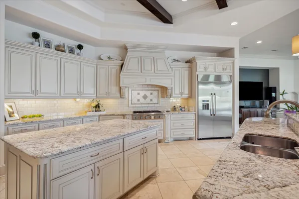 a kitchen with granite countertop a sink stainless steel appliances and cabinets