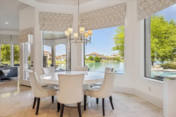 a dining room with furniture a chandelier and a rug