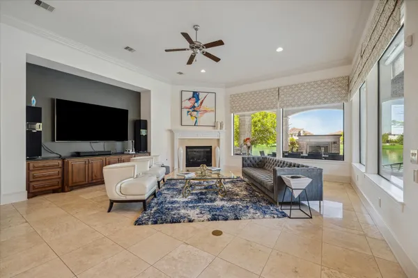 a living room with furniture a flat screen tv and a fireplace