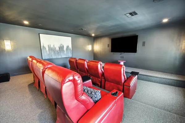 a outdoor living room with furniture and a flat screen tv