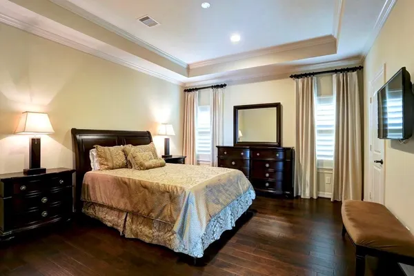 a bedroom with a bed and a tv on table