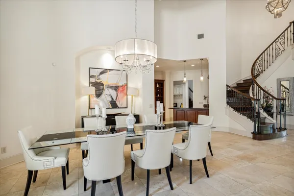 a view of a dining room with furniture and chandelier