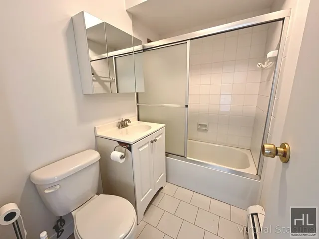 a white toilet sitting next to a bath tub shower