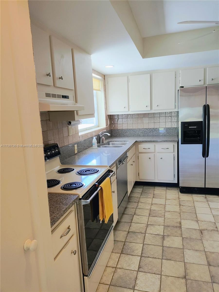 Kendall Miami, FL 33176 - Photo 20 of 28 a kitchen with a stove sink and cabinets