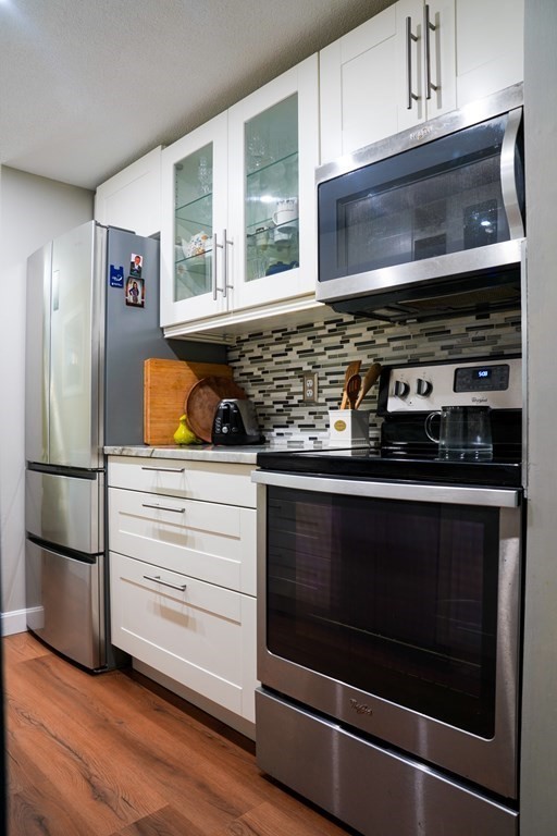 a kitchen with appliances and cabinets
