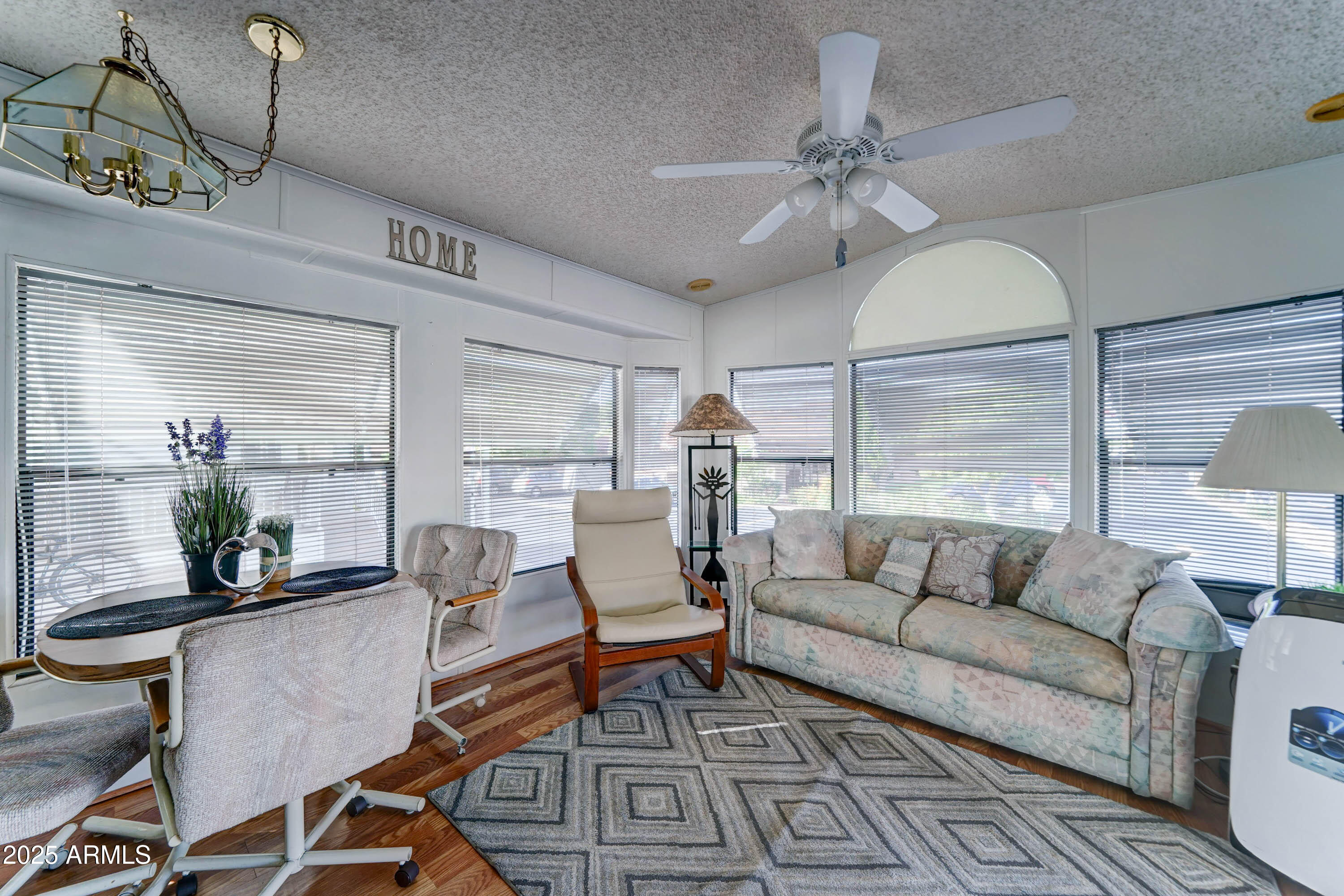 111 South Greenfield Road, Unit 481 Mesa, AZ 85206 - Photo 5 of 22 a living room with furniture a table and chairs