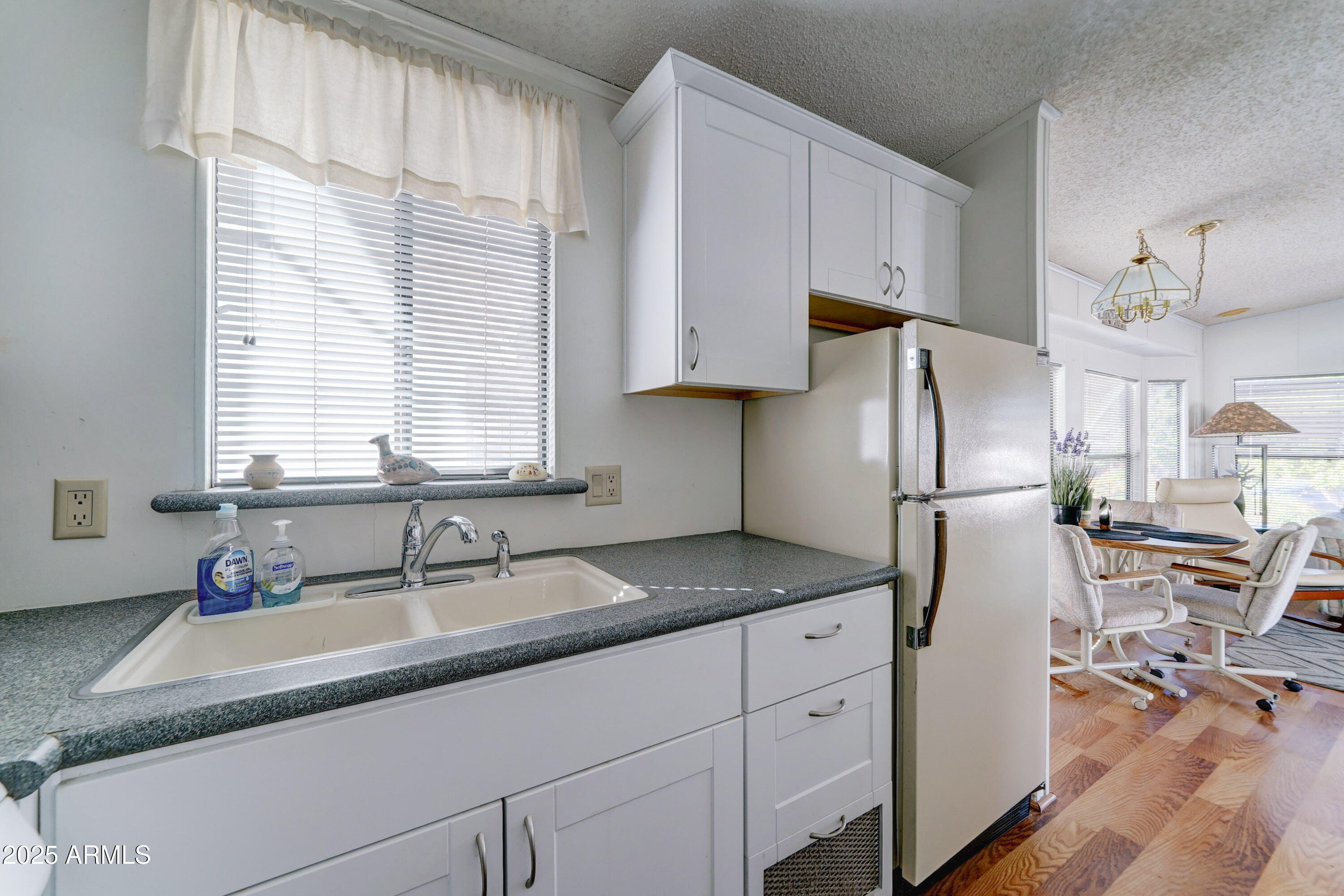 111 South Greenfield Road, Unit 481 Mesa, AZ 85206 - Photo 8 of 22 a kitchen with stainless steel appliances granite countertop a sink and a refrigerator