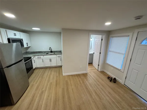 a kitchen with a wooden floor and a stove top oven