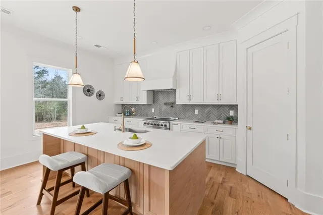 a kitchen with stainless steel appliances granite countertop a stove and a refrigerator