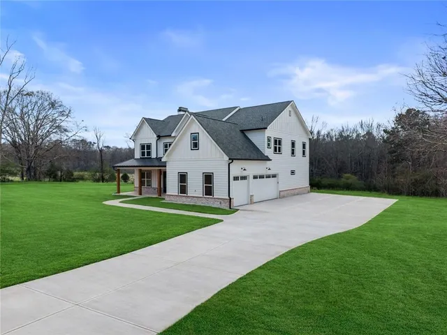 a front view of house with yard and green space