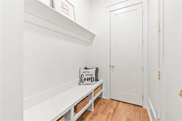 a bathroom with a granite countertop sink toilet a mirror a vanity and shower