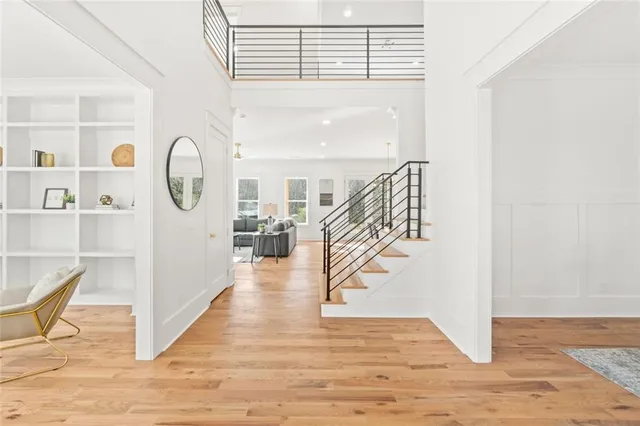 a living room with furniture a chandelier and a flat screen tv