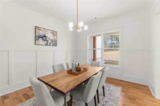 a living room with furniture a chandelier and a flat screen tv