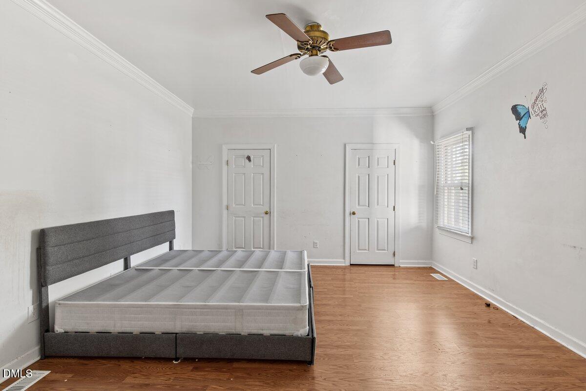 3812 Providence Road Rocky Mount, NC 27803 - Photo 10 of 18 a bedroom with a bed and a ceiling fan
