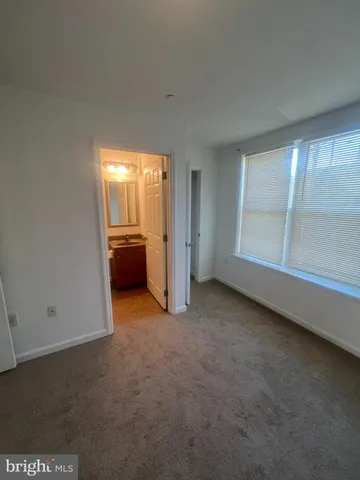 an empty room with furniture and a window