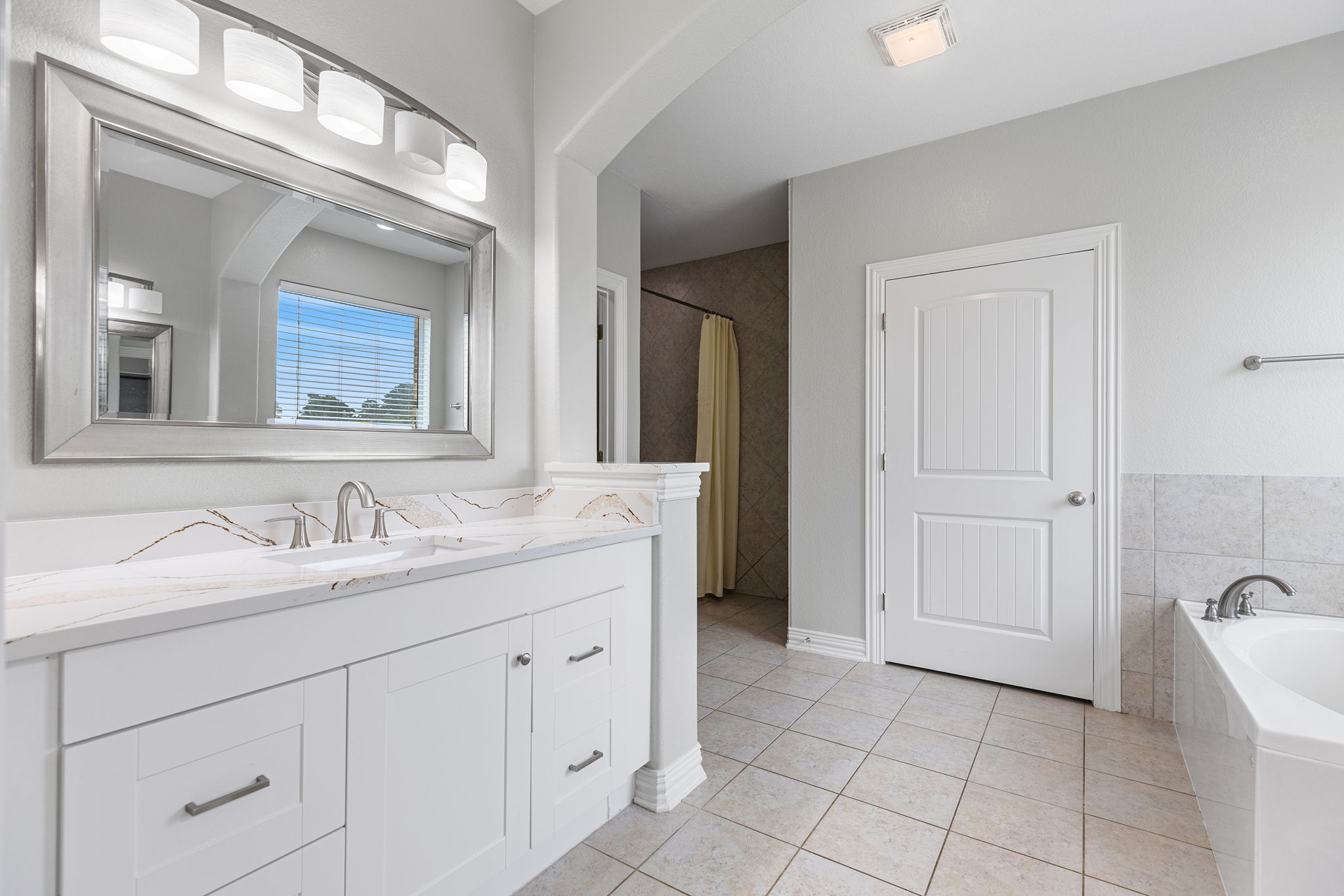237 Cardinal Drive Paige, TX 78659 - Photo 14 of 37 Bathroom with a garden tub, vanity, and light tile patterned floors