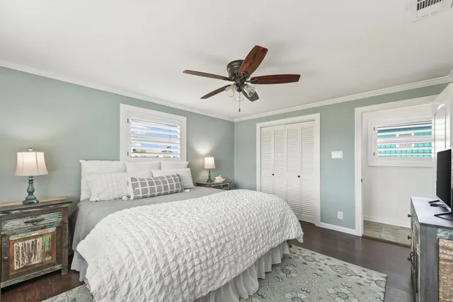 a bedroom with a bed and wooden floor