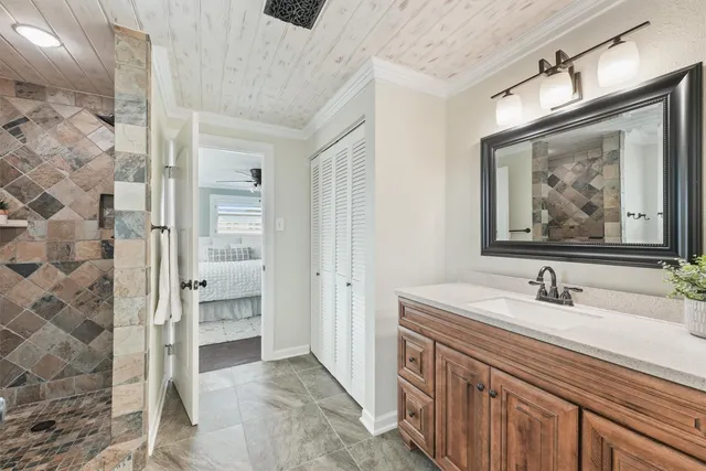 a bathroom with a double vanity sink mirror and shower