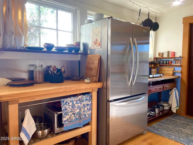 a kitchen with stainless steel appliances a refrigerator and a window