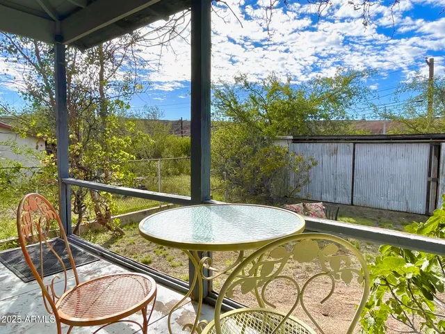 a view of a swimming pool with a patio and a yard