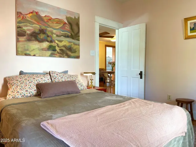 a bedroom with a bed and wall painting