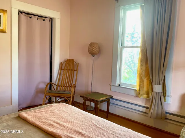 a bedroom with a bed and a window